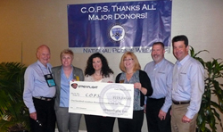Streamlight representatives present a check to C.O.P.S. Executive Director Dianne Bernhard (second from left) and Madeline Neumann, National President (fourth from left) during National Police Week.