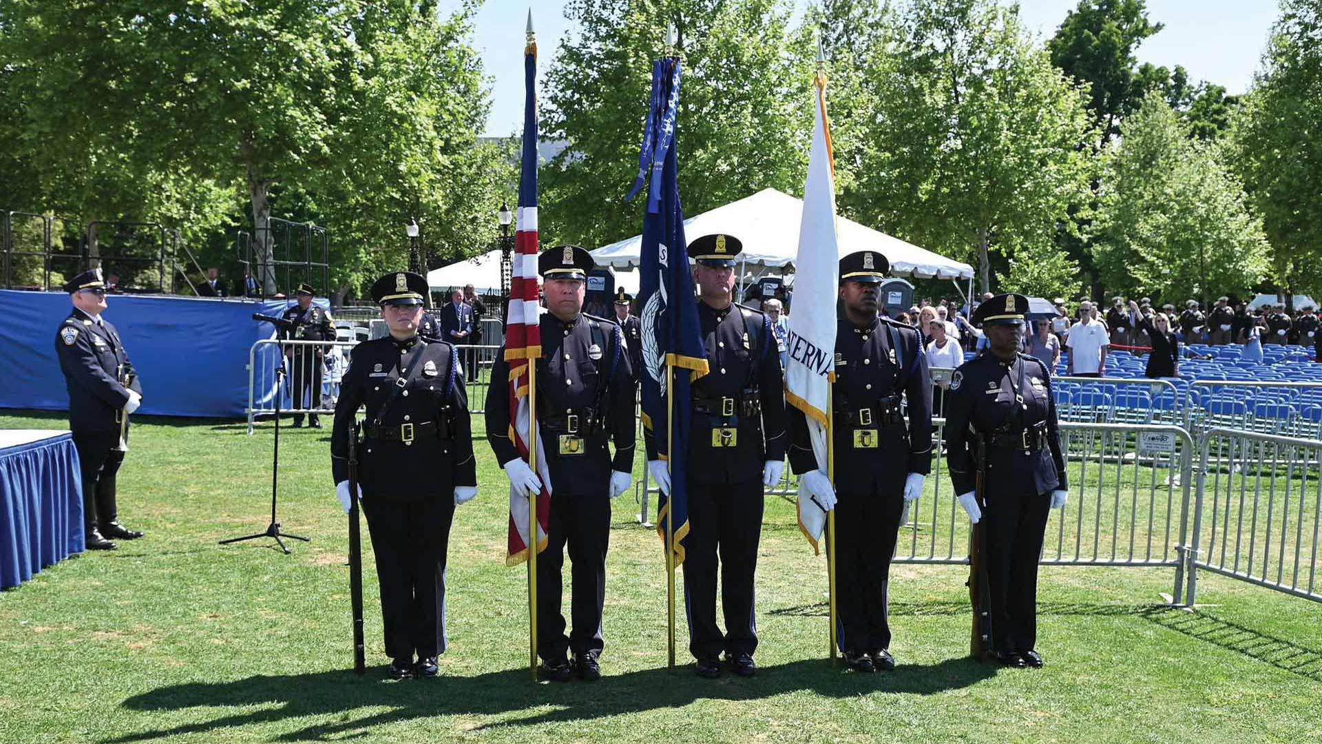 national-police-week-2022-10-an-honor-guard-stands-at-attention-at-the-memorial-service
