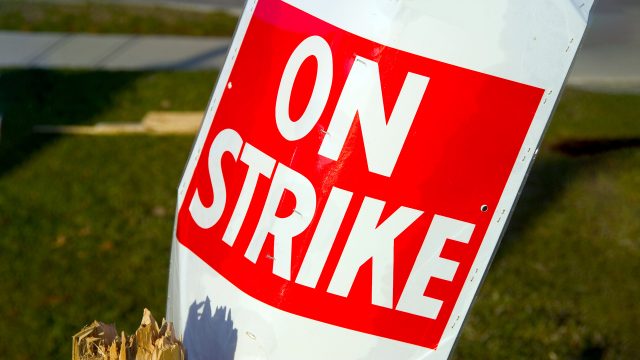 https://files.apbweb.com/wp-content/uploads/2023/12/union-strike-labor-safety-wages-contract-pay-On-Strike-sign-red-white-poster-640x360.jpg